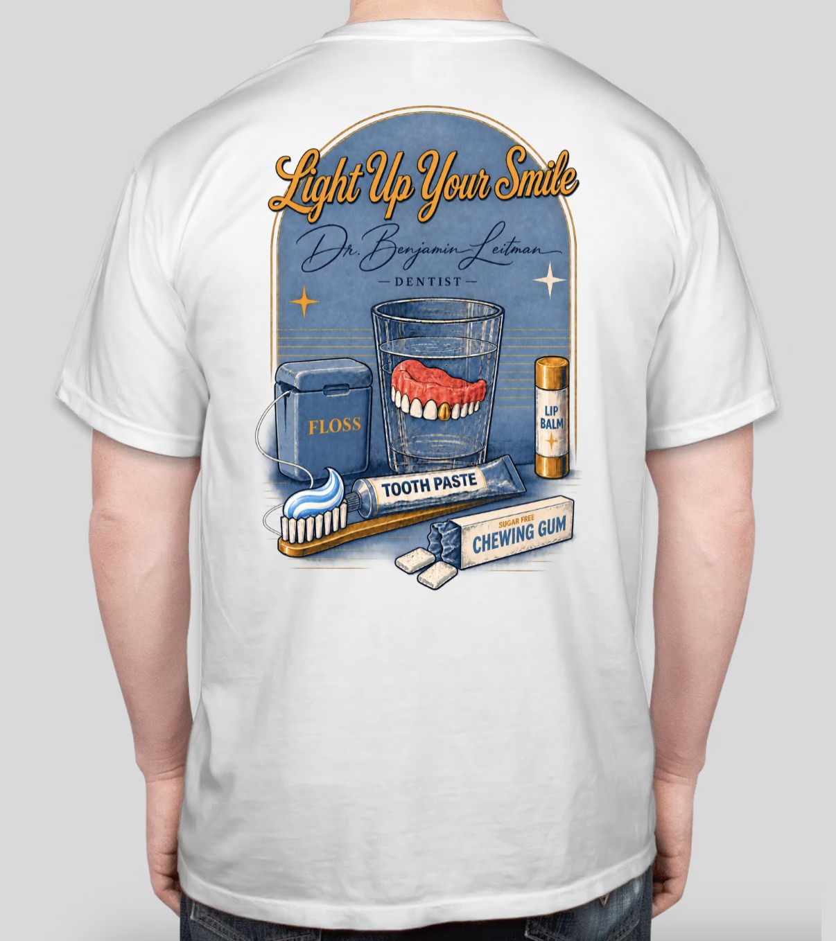 Back of white Light Up Your Smile Tee with dental essentials illustration